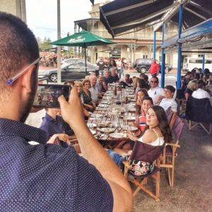 outdoor dining at henley square. Estia Restaurant long table family dinner